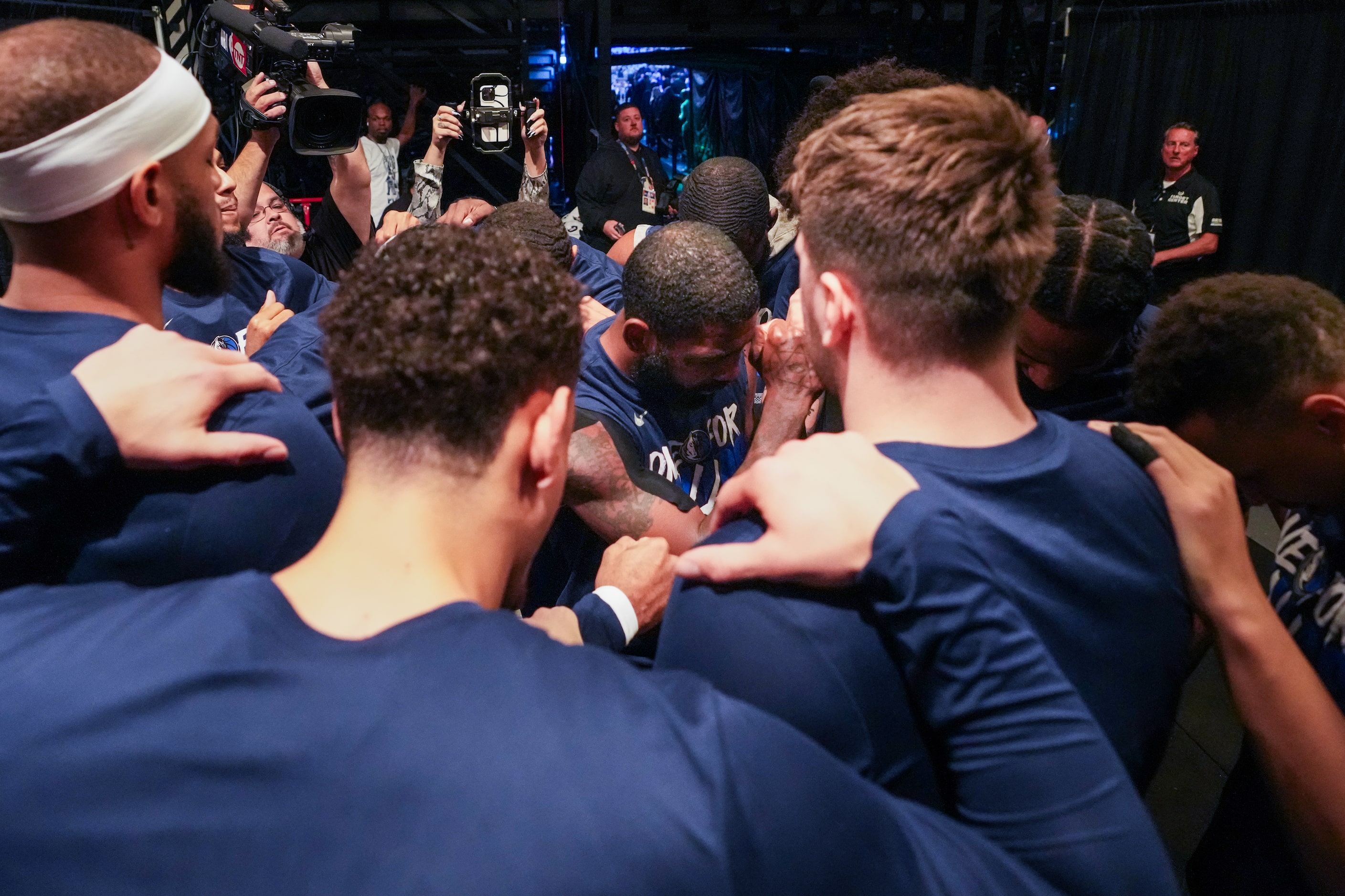 Dallas Mavericks players huddle in the tunnel before taking the court for Game 5 of the NBA...