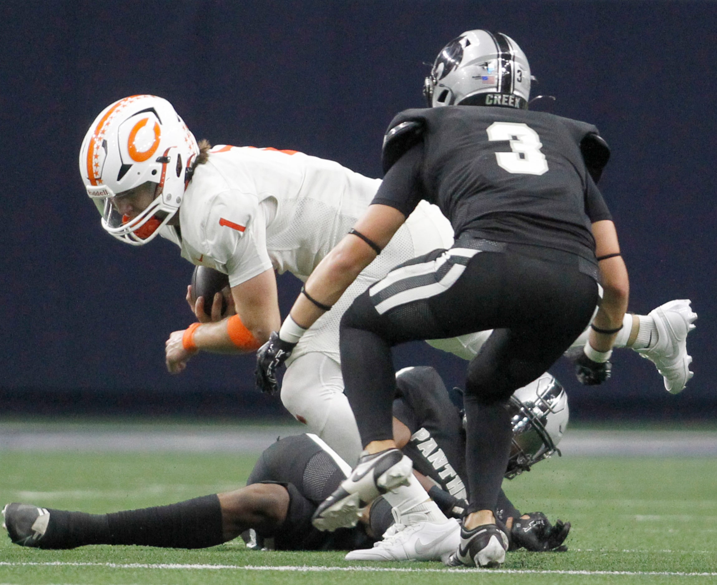 Celina quarterback Bowe Bentley (1) is stopped by Frisco Panther Creek defensive backs...