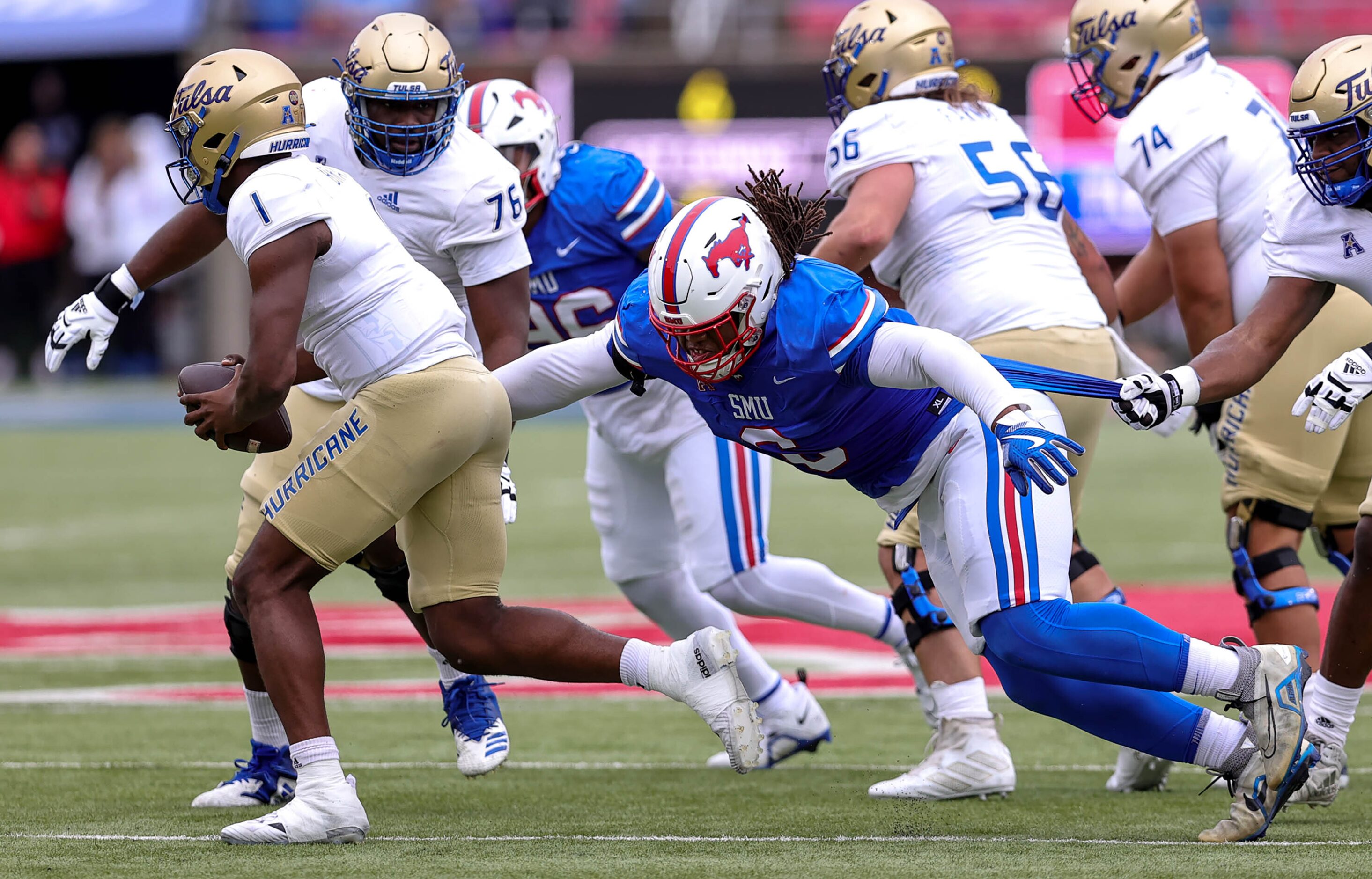 SMU nose tackle Jordan Miller (right) gets a sack on Tulsa quarterback Braylon Braxton (1)...