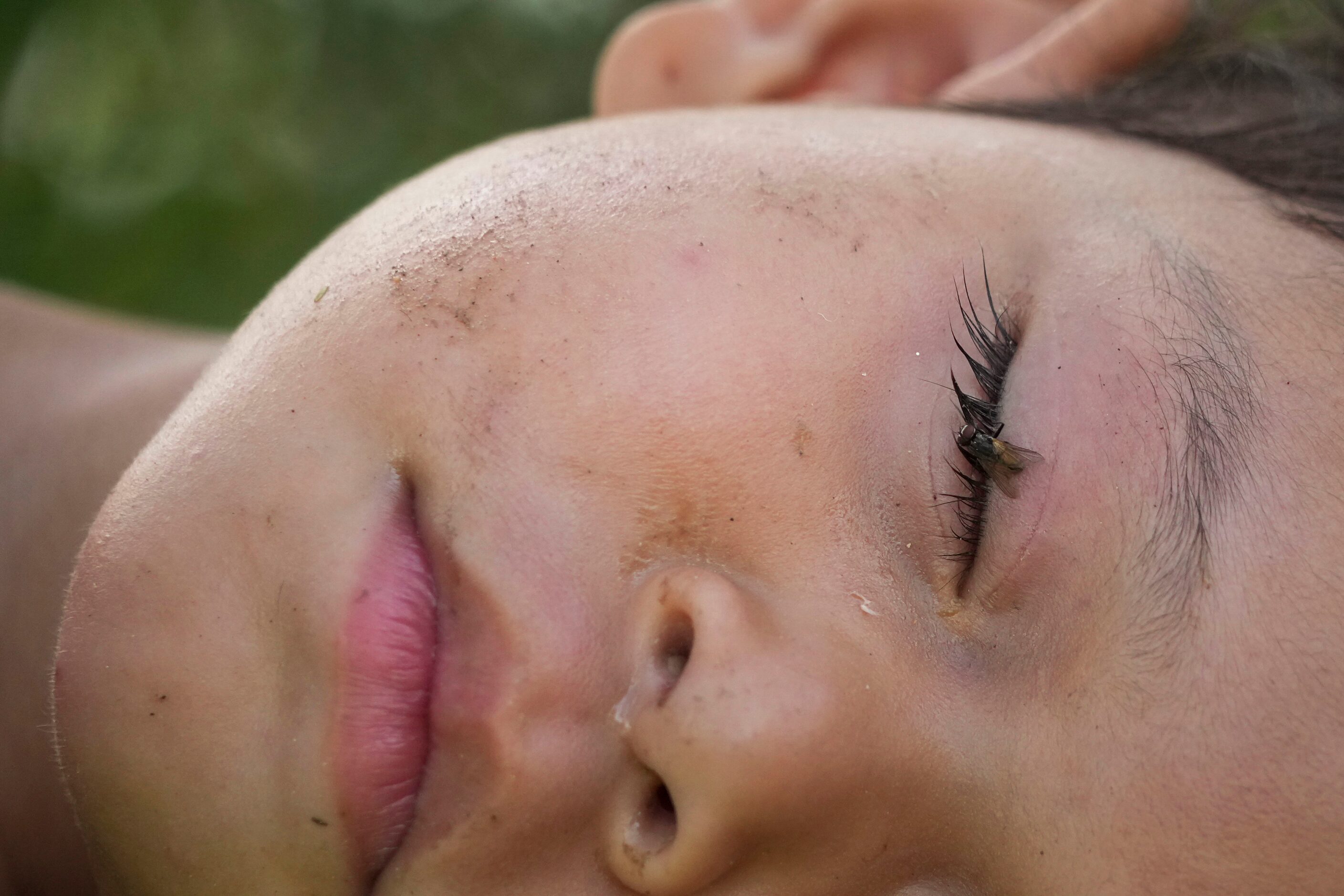 Alexis, a migrant from Nicaragua, sleeps in the arms of her father Wilber on Wednesday, Aug....