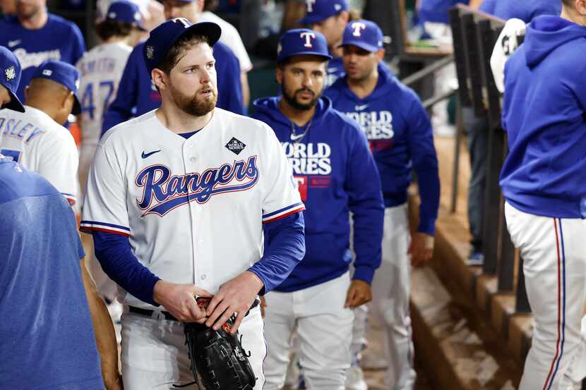 Texas Rangers starting pitcher Jordan Montgomery walks through the dugout after giving up an...