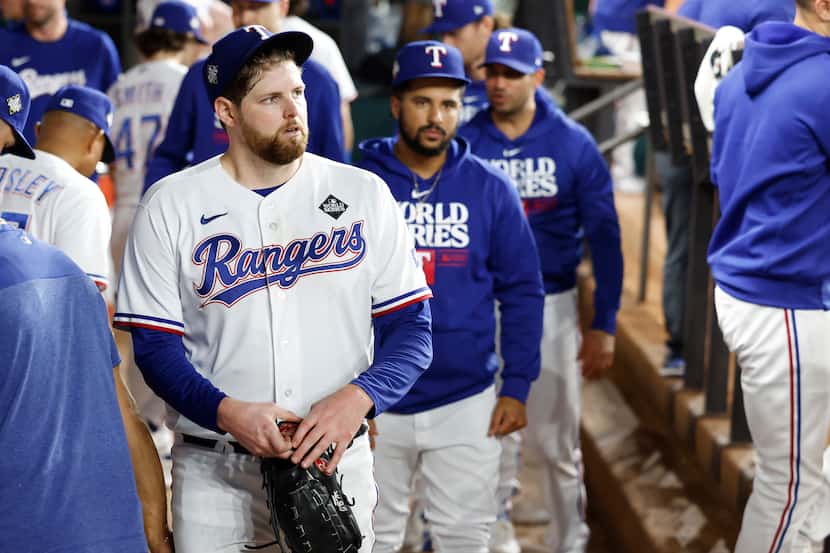 Texas Rangers starting pitcher Jordan Montgomery walks through the dugout after giving up an...