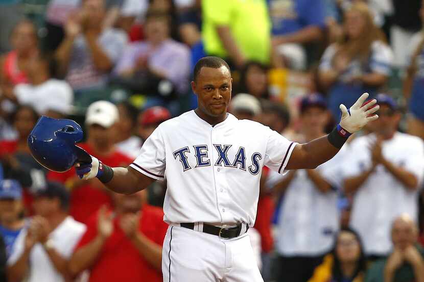 Texas Rangers' Adrian Beltre acknowledges fans' applause after hitting a single for his...
