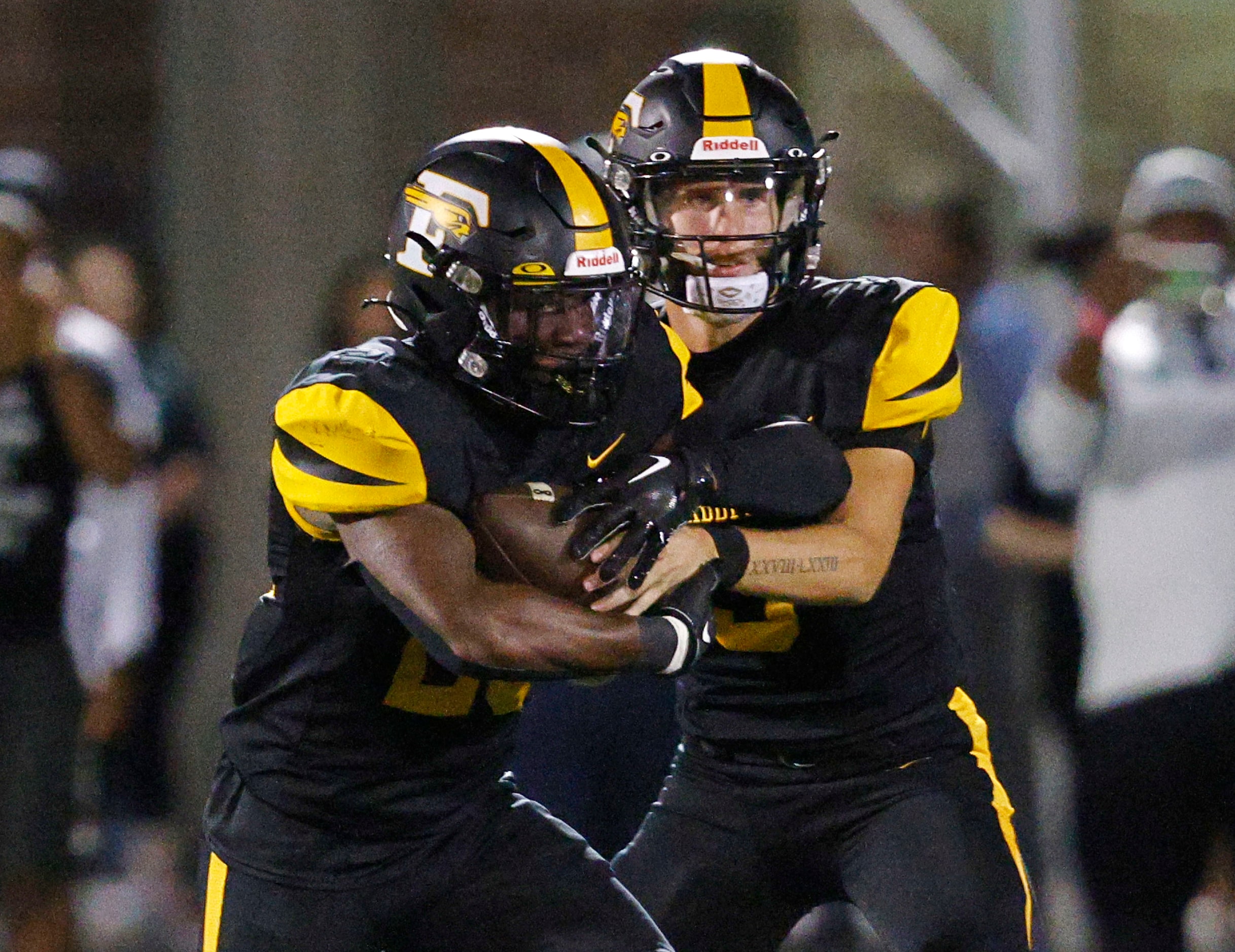 Forney's quarterback Kyle Crawford (3) hands off to Forney's Javian Osborne (26) during the...