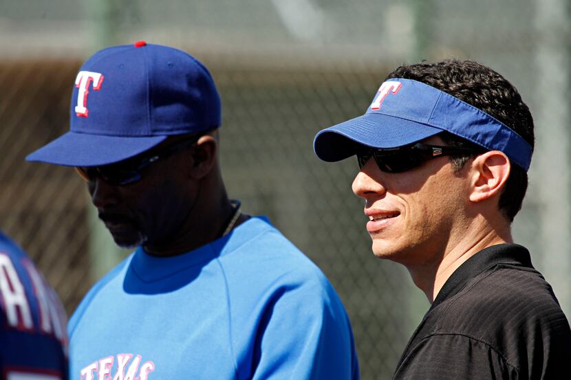 Texas Rangers general manager Jon Daniels looks on during spring training camp Sunday,...