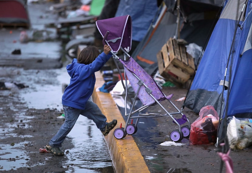 A child pushes a stroller outside a closed temporary migrant shelter in Tijuana, Mexico. 