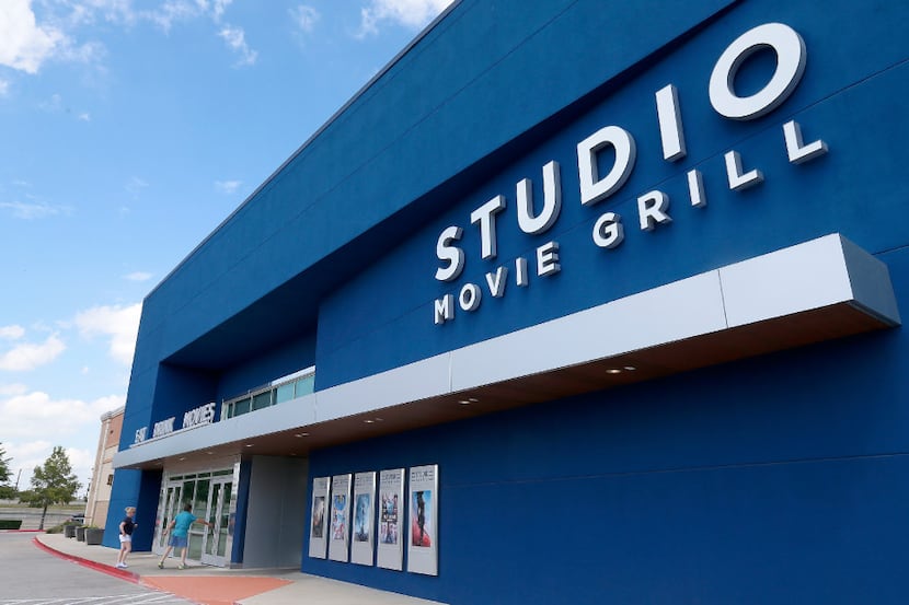 People walk into the Studio Movie Grill in The Colony. The Studio Movie Grill offers a...