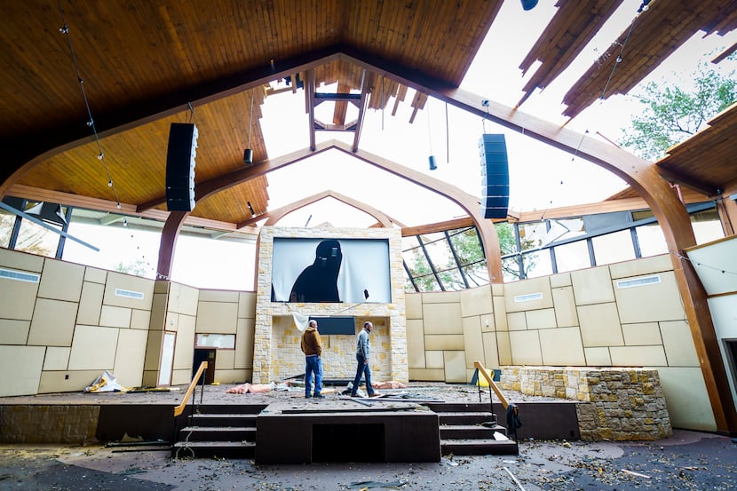Northway Church lead pastor Shea Sumlin, right, surveys the damage to the sanctuary with...