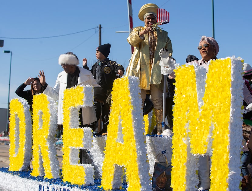 The MLK Board waves as they make their way down Martin Luther King Jr. Blvd during the 38th...