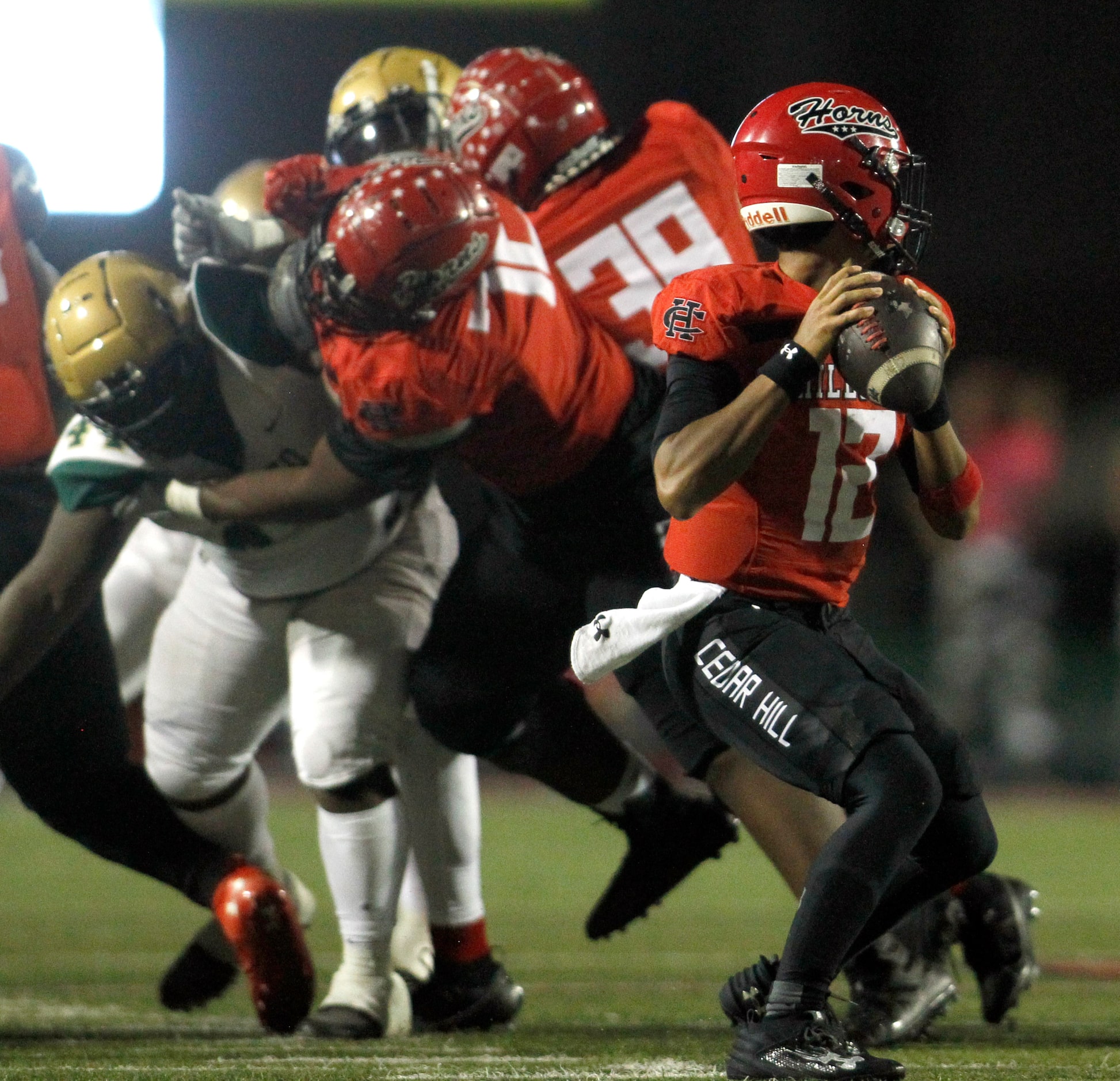 Cedar Hill quarterback Anthony Edwards (12) prepares to launch a pass downfield as his...