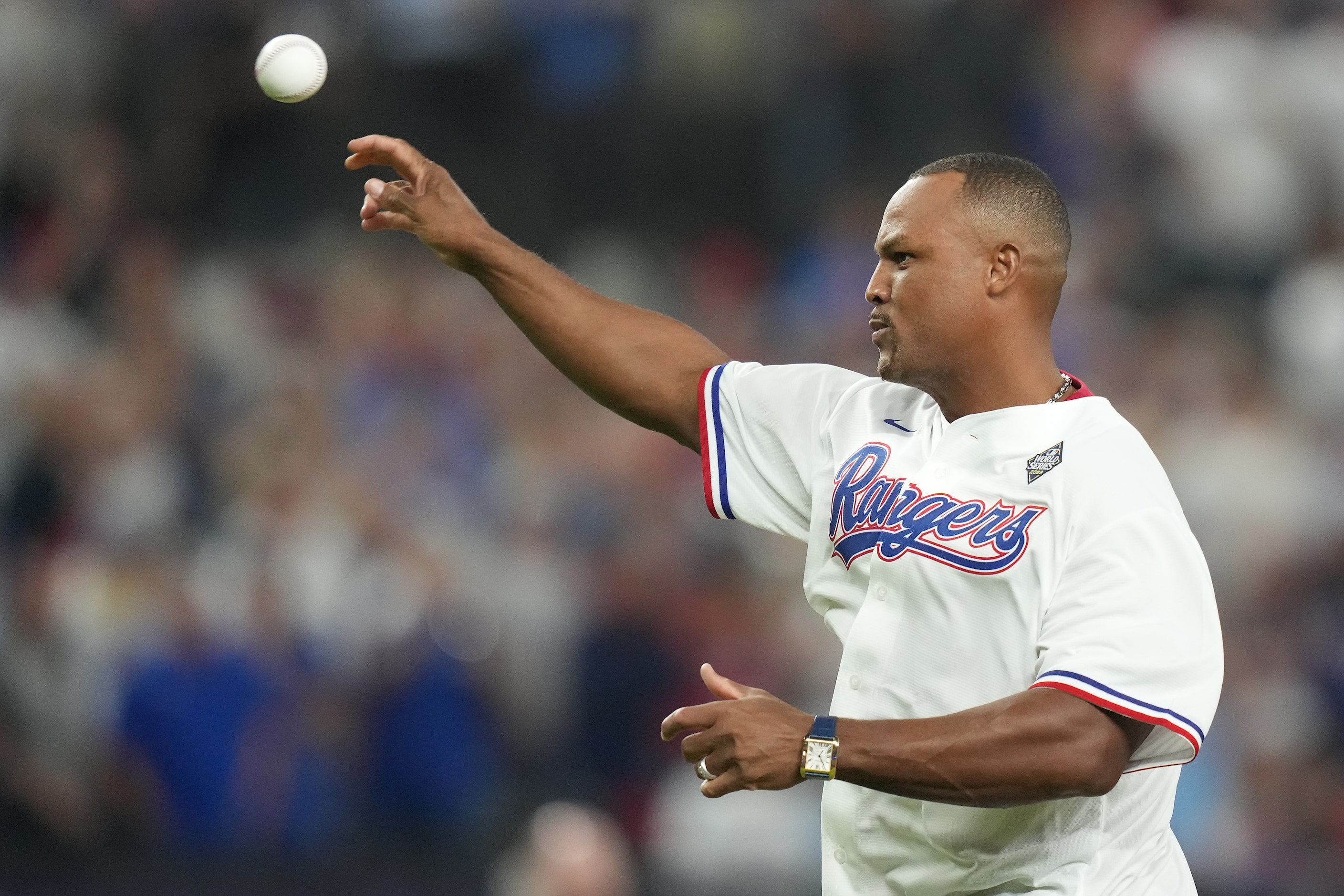 Former Texas Rangers third baseman Adrián Beltré throws the ceremonial pitch to former...