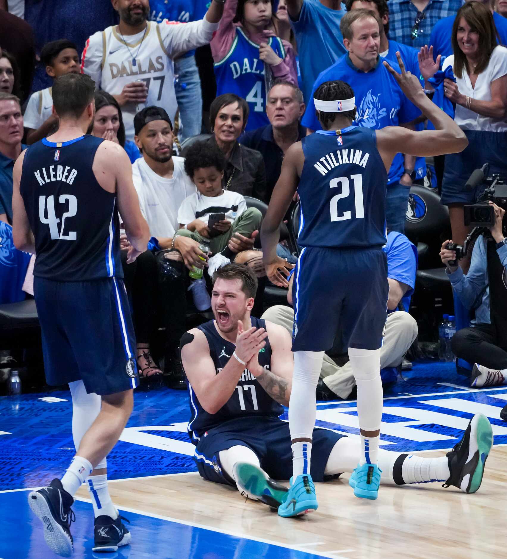 Dallas Mavericks guard Luka Doncic (77) celebrates with forward Maxi Kleber (42) and guard...