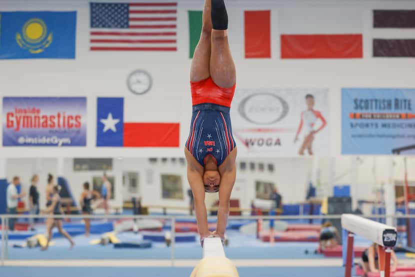 Gymnast Konnor McClain, 17, practices handstand on the balance beam during her regular...