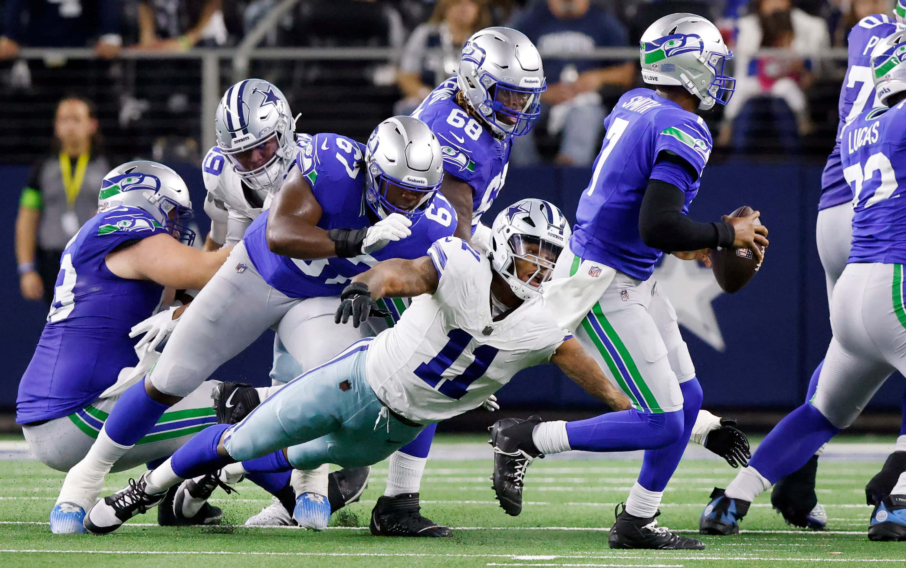 Dallas Cowboys linebacker Micah Parsons (11) dives and trips Seattle Seahawks quarterback...