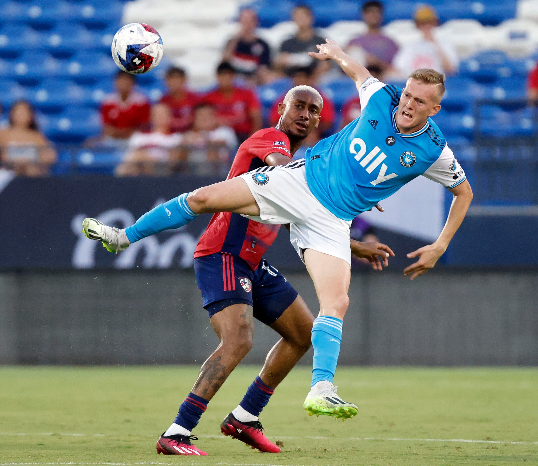 Charlotte FC forward Karol Świderski (11) goes flying as he tries to secure the ball as FC...