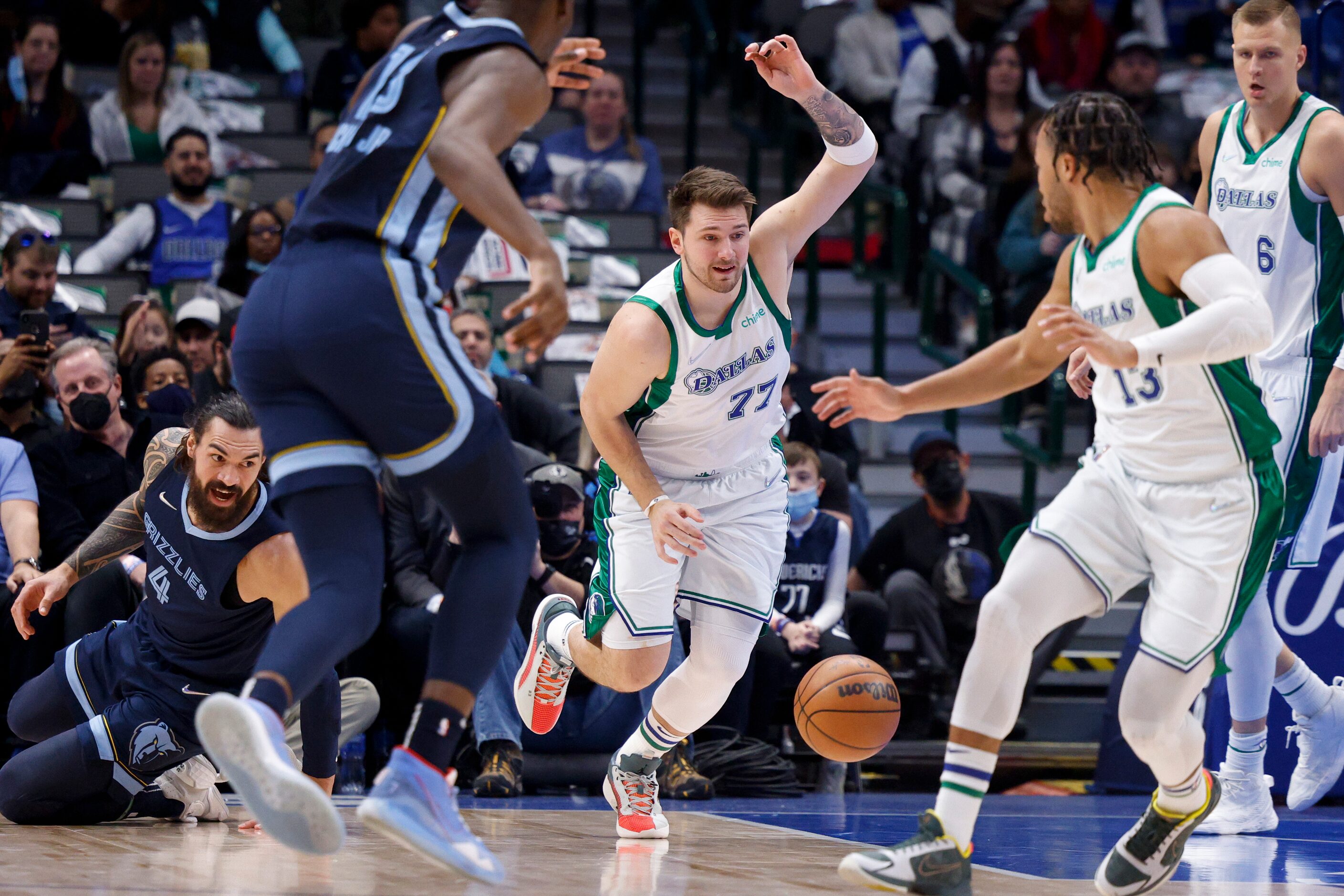 Dallas Mavericks guard Luka Doncic (77) pushes the ball up the court during the first...