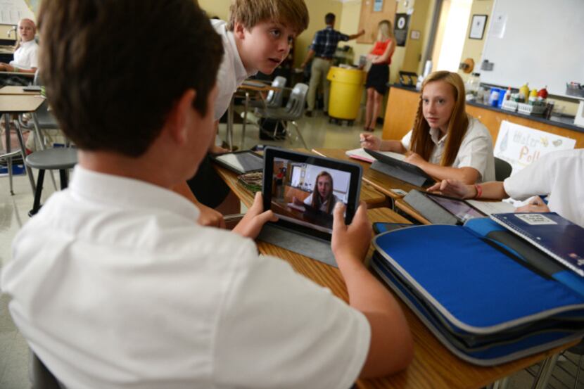 Luke Logan displays classmate Emma Boeckman on his iPad's video camera, which is then...