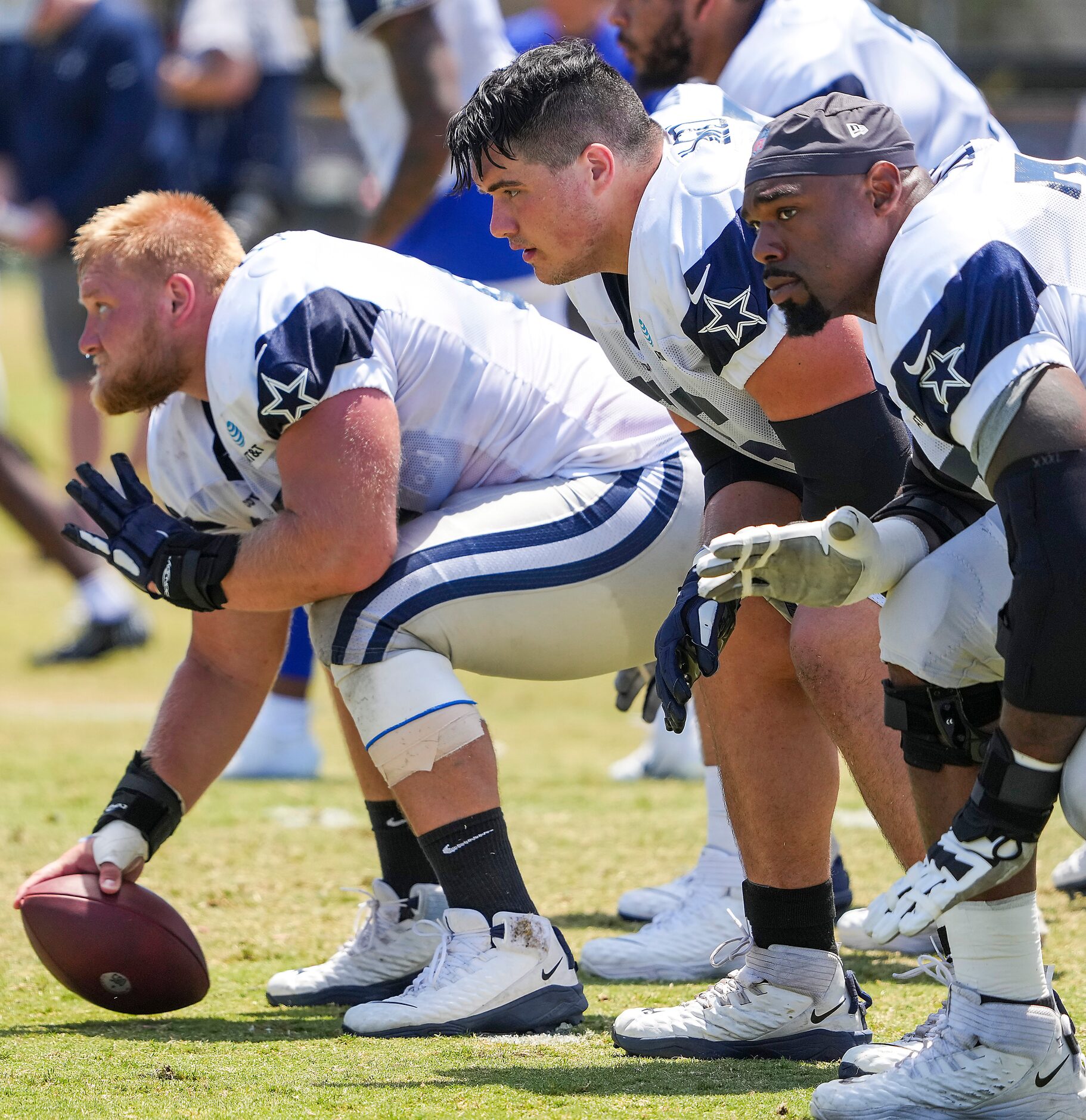 Dallas Cowboys center Tyler Biadasz (63) prepares for a snap alongside guard Connor McGovern...