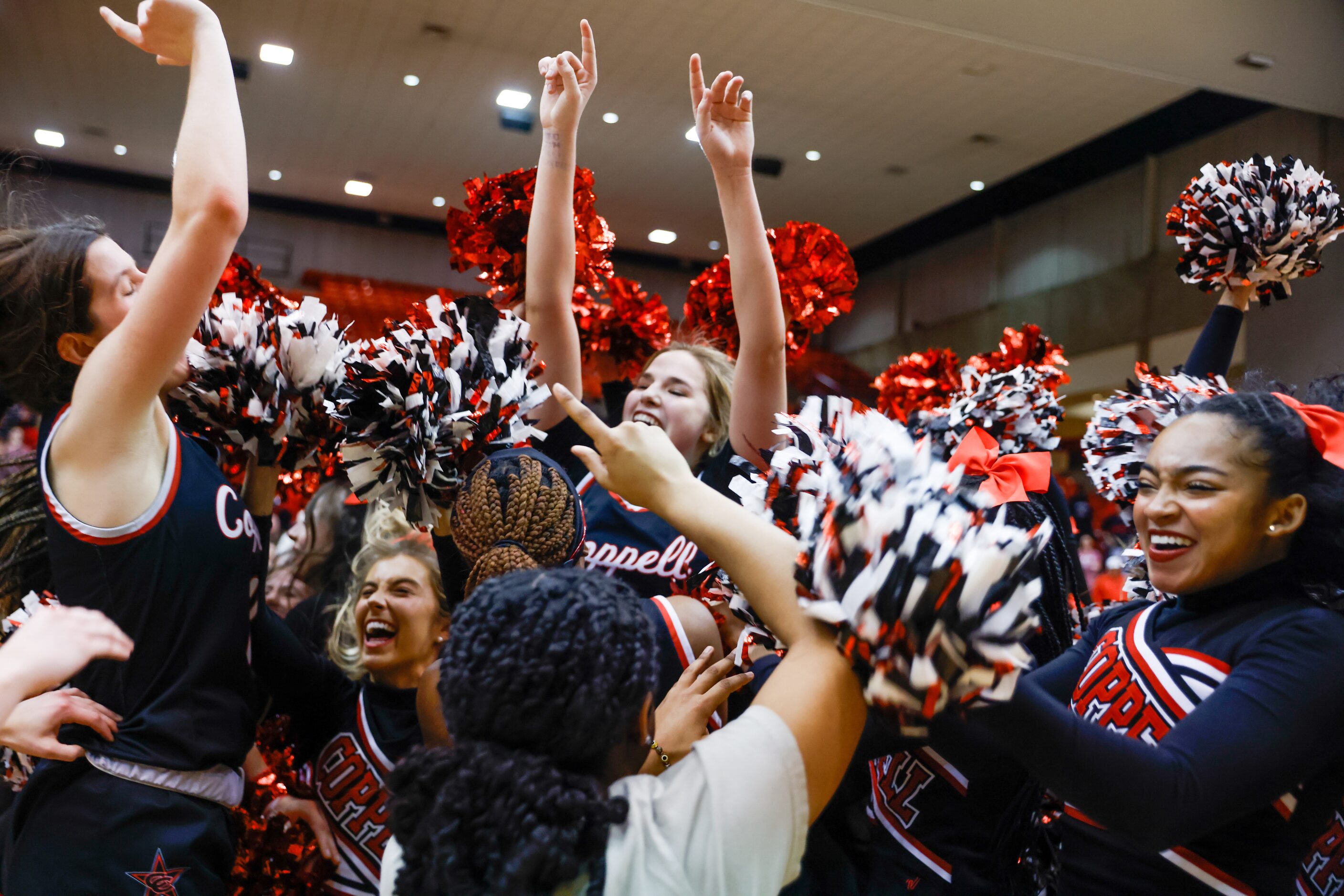 Coppell players and students celebrate their win over Southlake Carroll in a Class 6A Region...