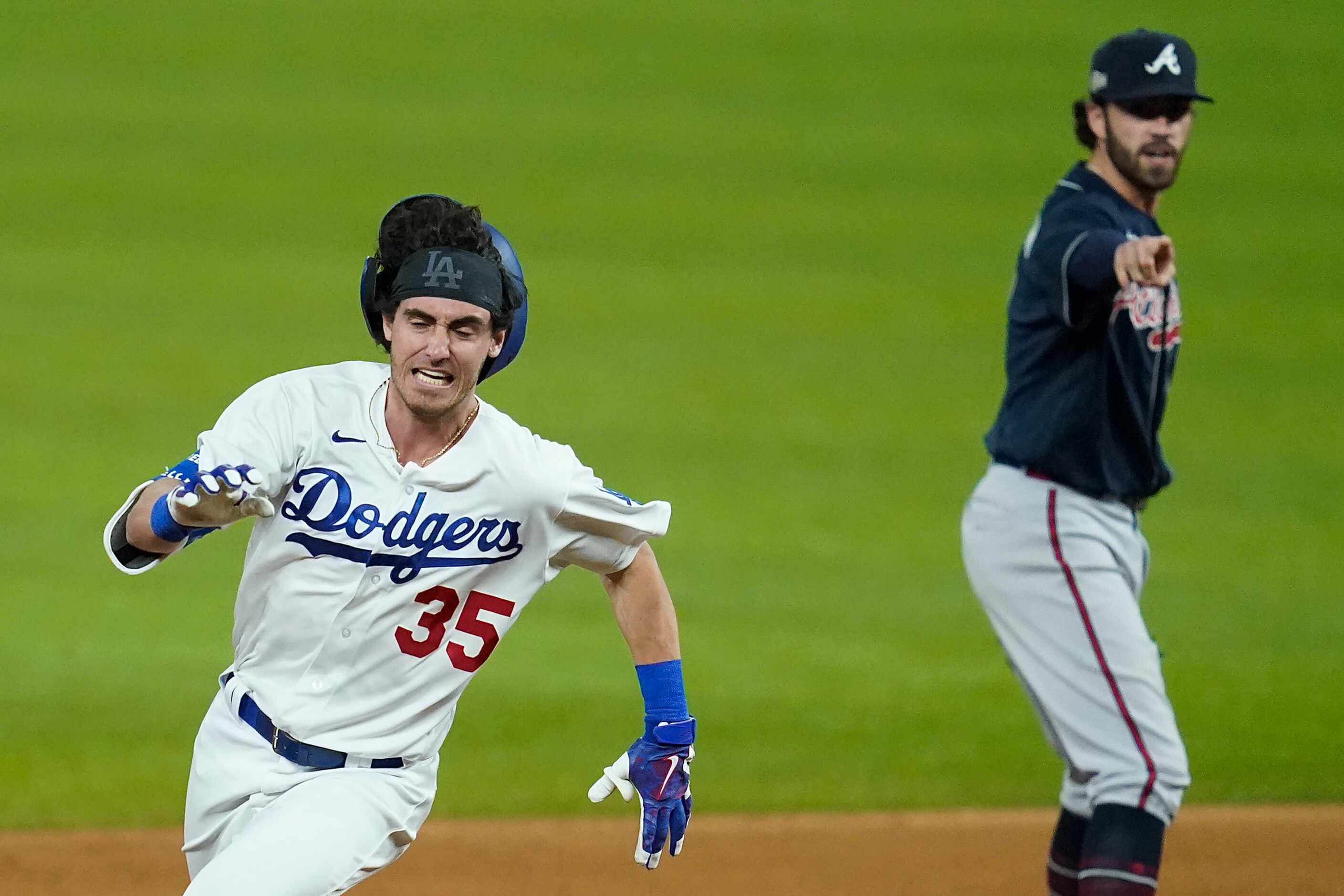 Los Angeles Dodgers center fielder Cody Bellinger rounds second base as Atlanta Braves...