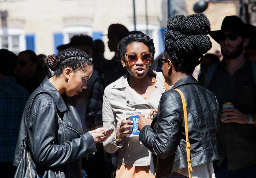Dallas residents Rayvn Robbins, Kayla Williams and Danielle Brown chat as they try to figure...