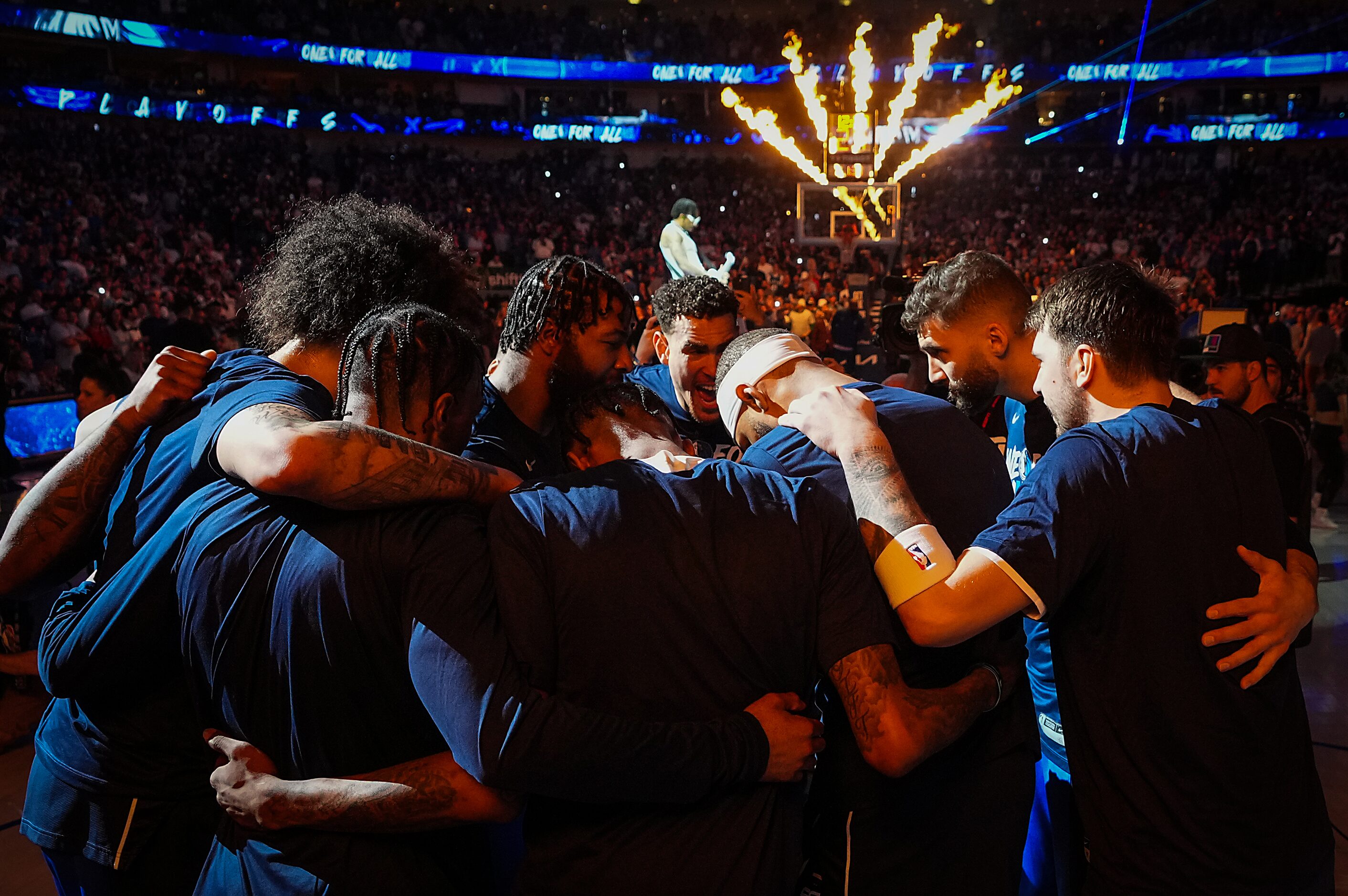 Dallas Mavericks players, including guard Luka Doncic (right) huddle before Game 4 of an NBA...