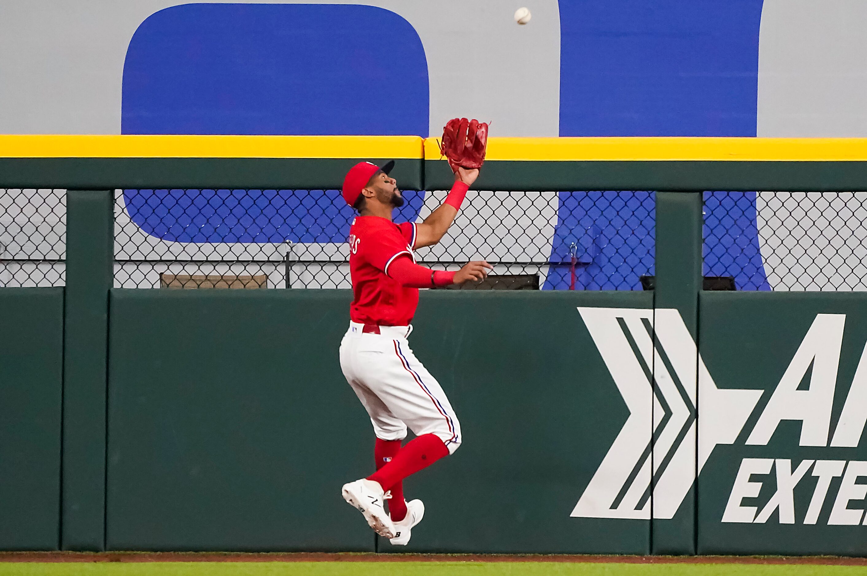 Texas Rangers center fielder Leody Taveras makes a catch on a fly ball to the warning track...