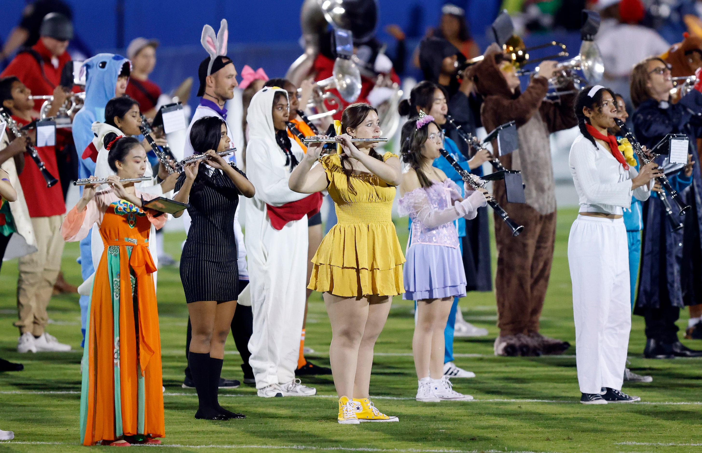 Memebers of the Frisco Independence marching band dressed for Halloween as they performed...