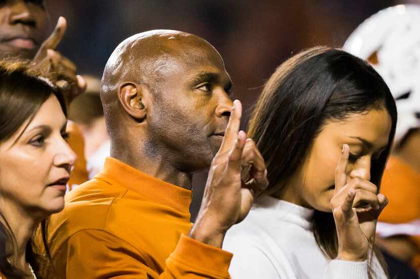 Texas head coach Charlie Strong stands for the playing of the "Eyes of Texas" after a loss...