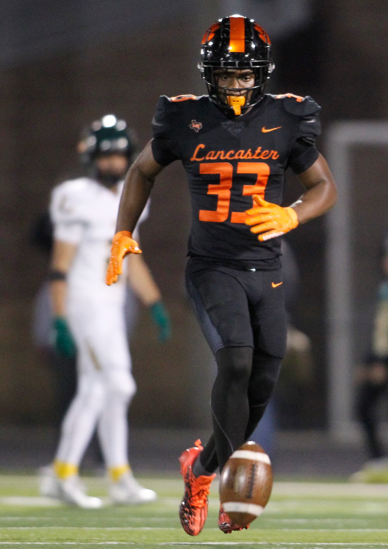 Lancaster linebacker Givens Igwe (33) tracks the ball before downing it after a punt during...