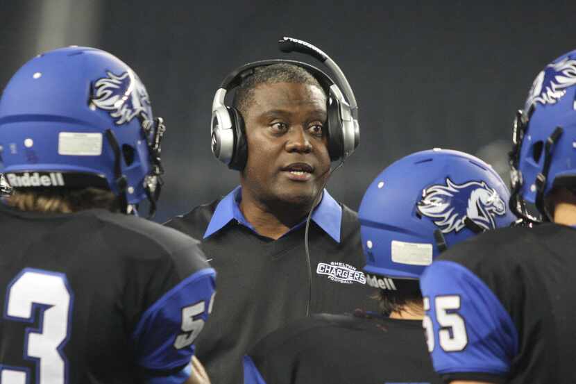 Shelton head caoch George Teague (center) talks to his players during a game against Parish...