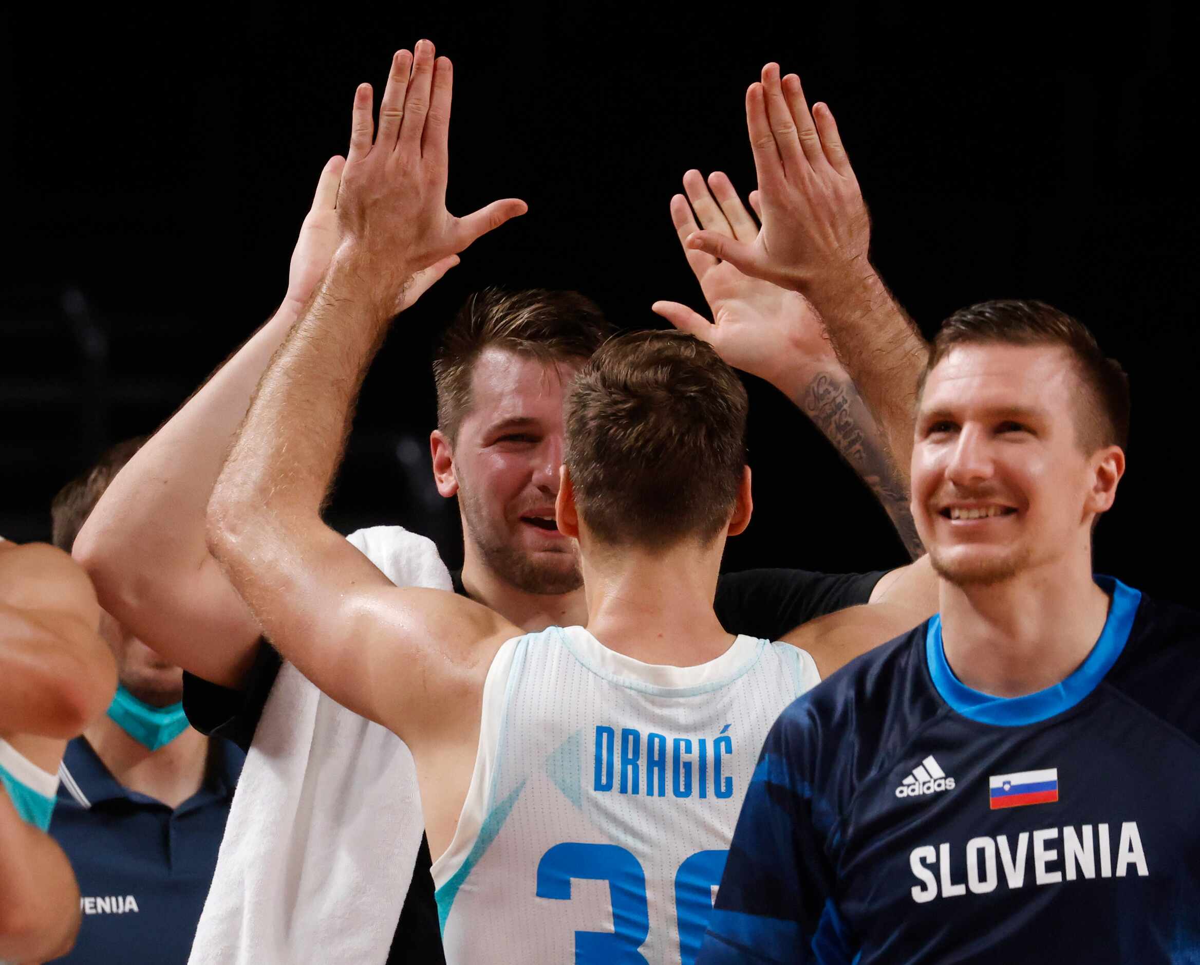 Slovenia’s Luka Doncic (77) celebrates with Zoran Dragic (30) after both were pulled from...