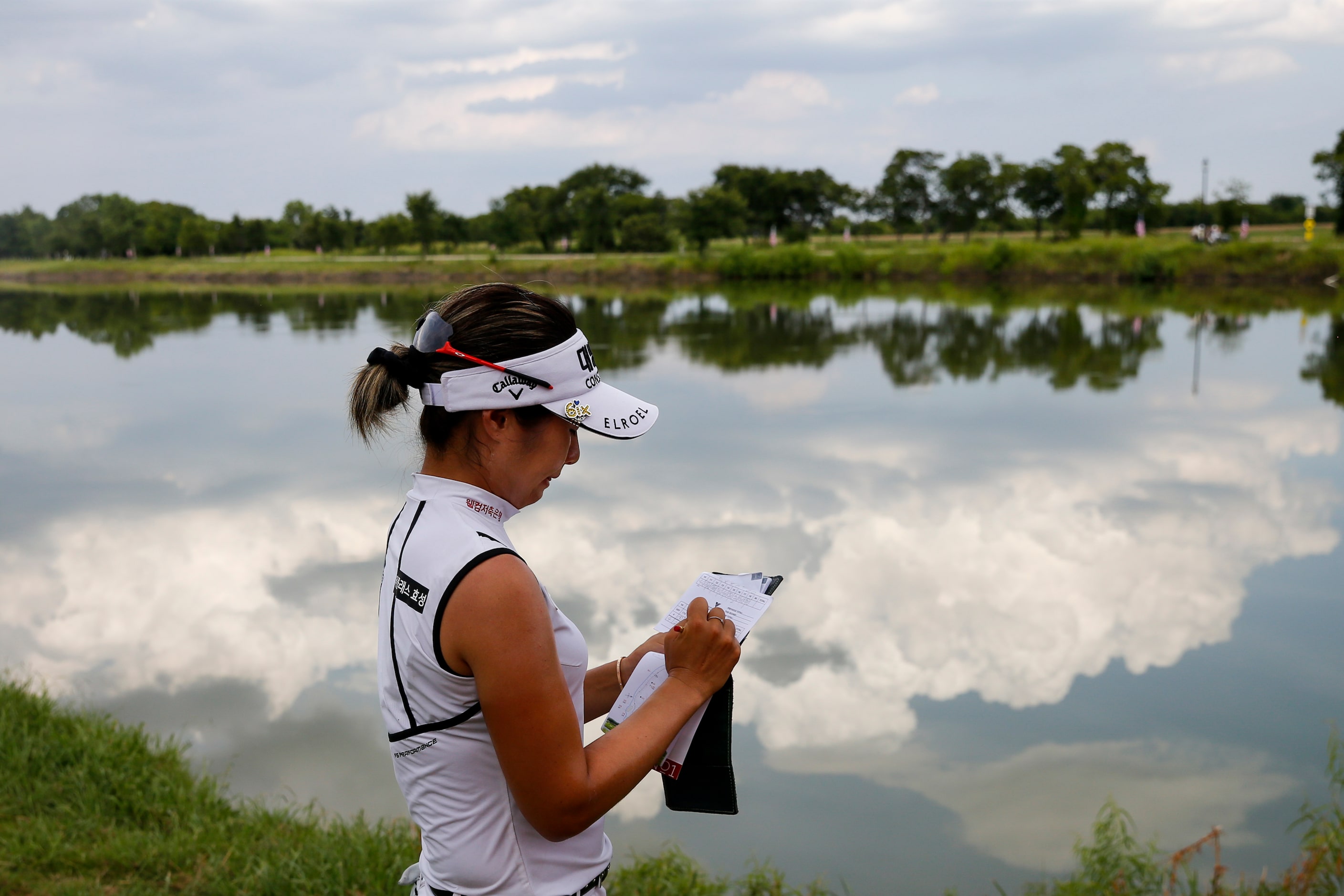 Professional golfer Jeongeun Lee6 signs her scorebook after recording a birdie on the 18th...