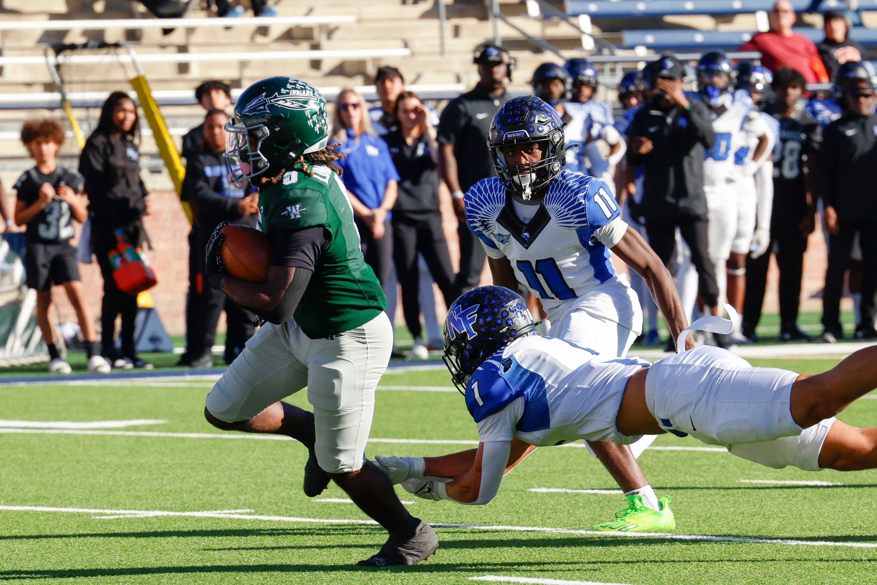 Waxahachie High’s Bryson Linnear (left) runs a touchdown past North Forney’s Caleb Holt (1) ...