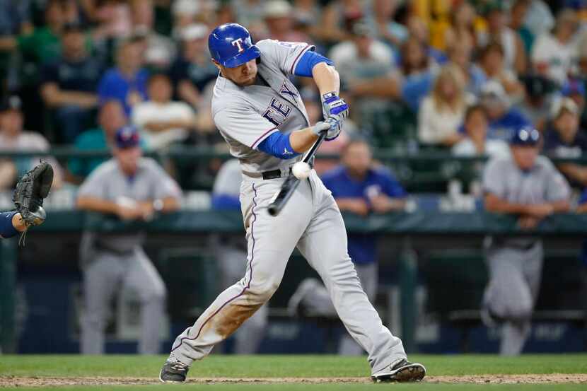 Aug 8, 2015; Seattle, WA, USA; Texas Rangers catcher Chris Gimenez (38) hits a 2-run RBI...