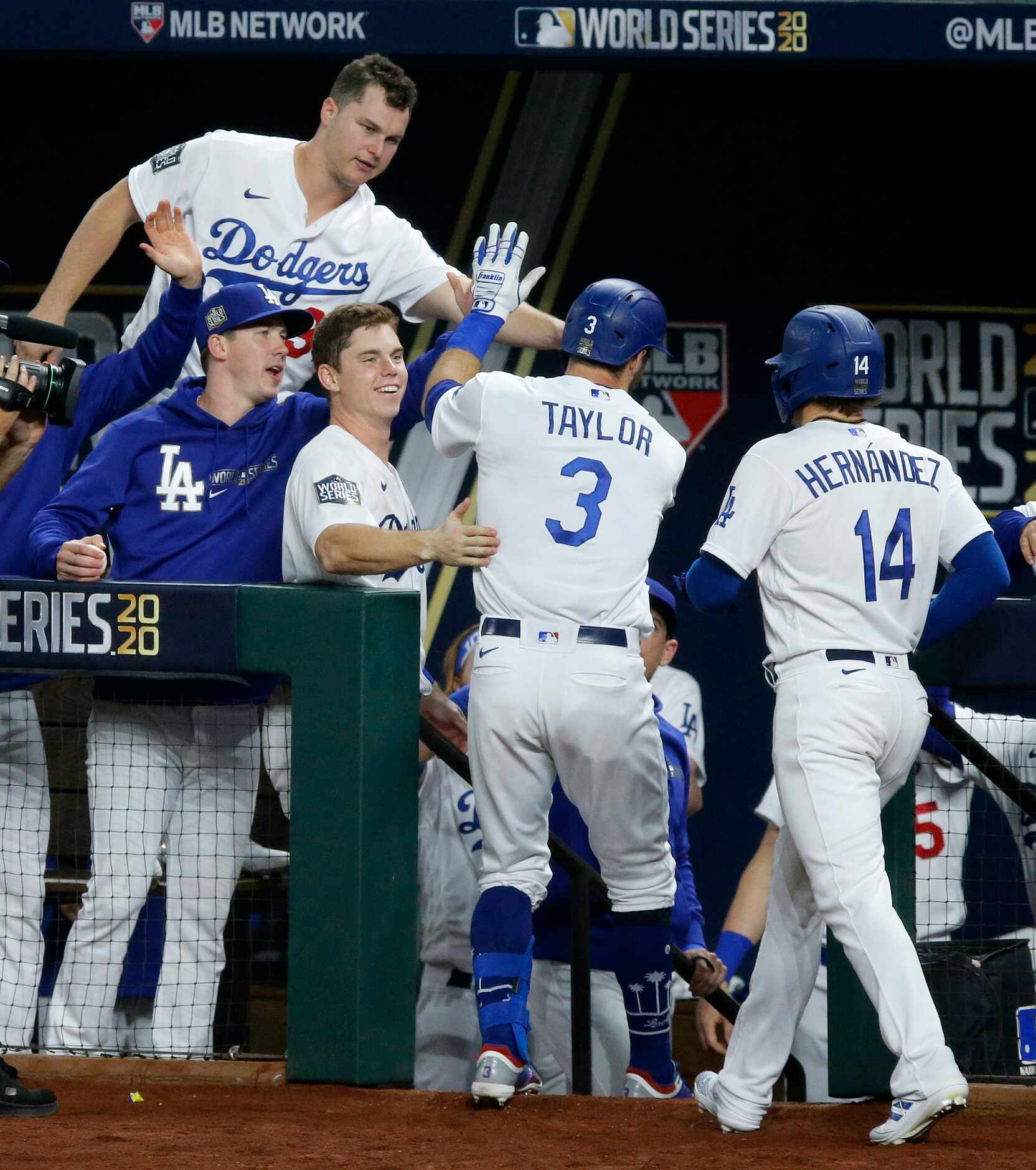 Los Angeles Dodgers left fielder Chris Taylor (3) is congratulated by teammates after...