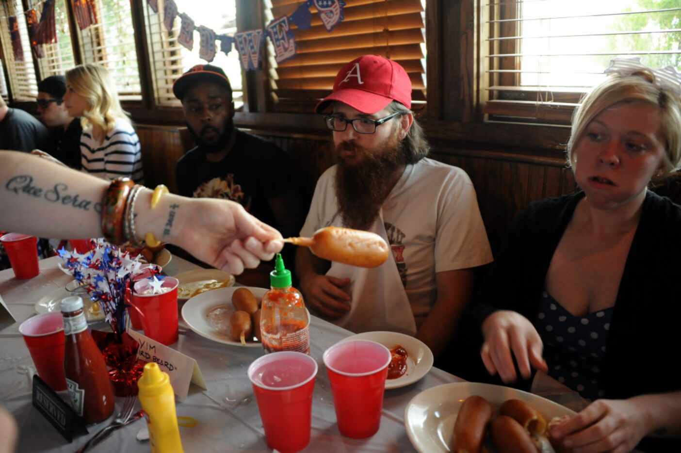 Tim Jackson and Jessica Mechem eat corn dogs at the 7th annual Brass Knuckles Corn Dog...