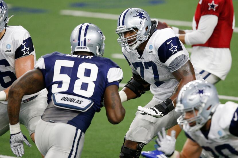 Dallas Cowboys offensive tackle Tyron Smith (77) looks to block Dallas Cowboys defensive end...