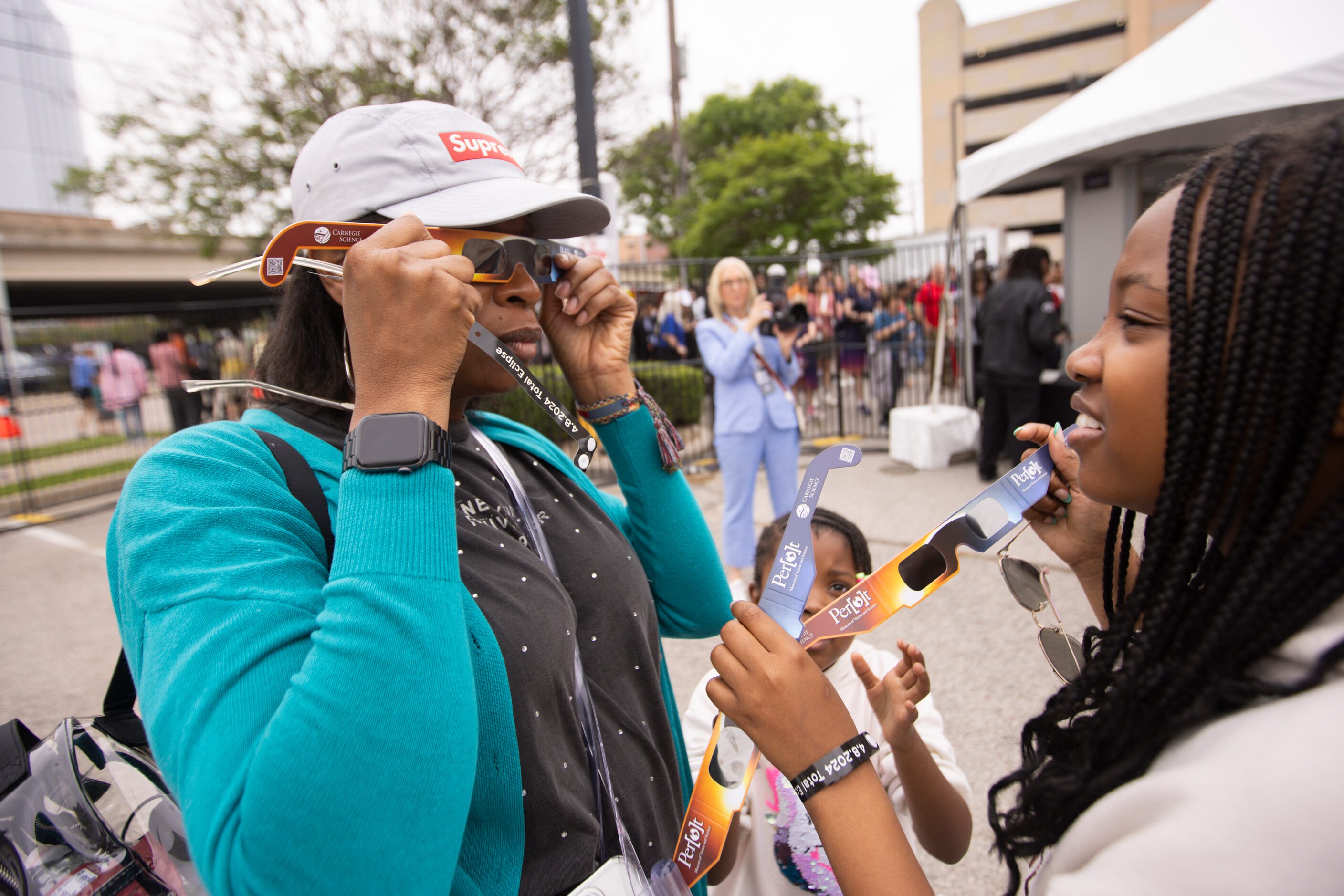 Deb Phillip of Frisco tries on her eclipse glasses while attending the Great North American...