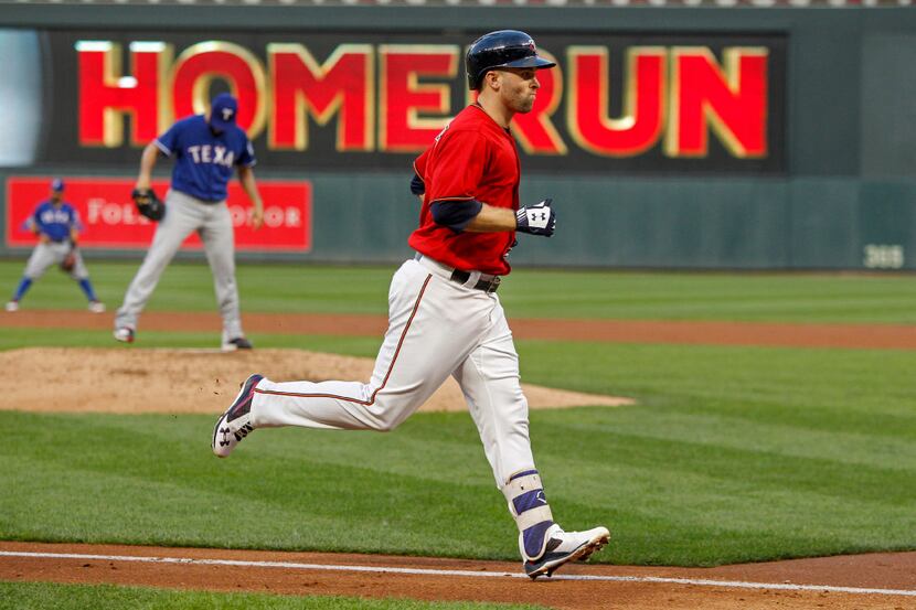 Minnesota Twins Brian Dozier runs the bases on his second home run of the night against...