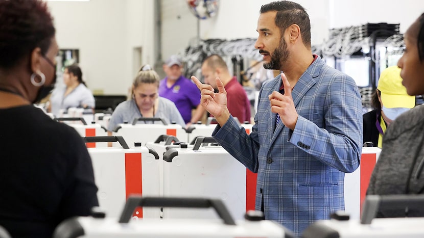 Former Tarrant County elections administrator Heider Garcia talks to employees testing...