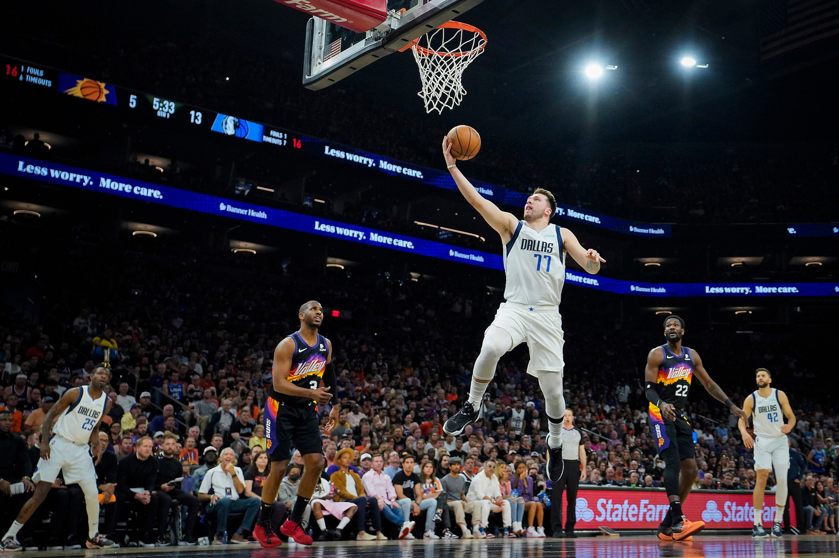 Dallas Mavericks guard Luka Doncic (77) goes for a layup past Phoenix Suns center Deandre...