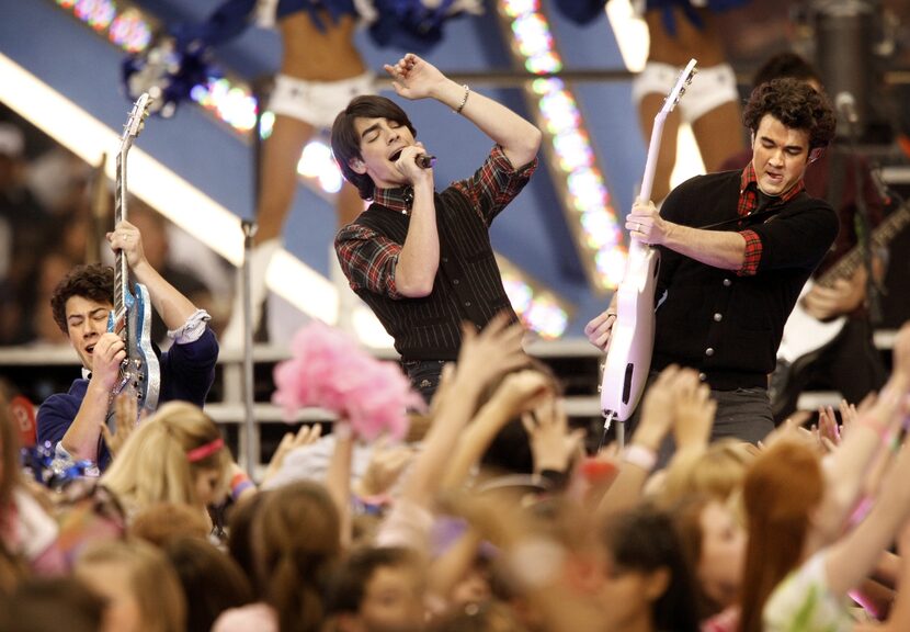 The Jonas Brothers (from left) Nick, Joe and Kevin jam during the Thanksgiving halftime show...