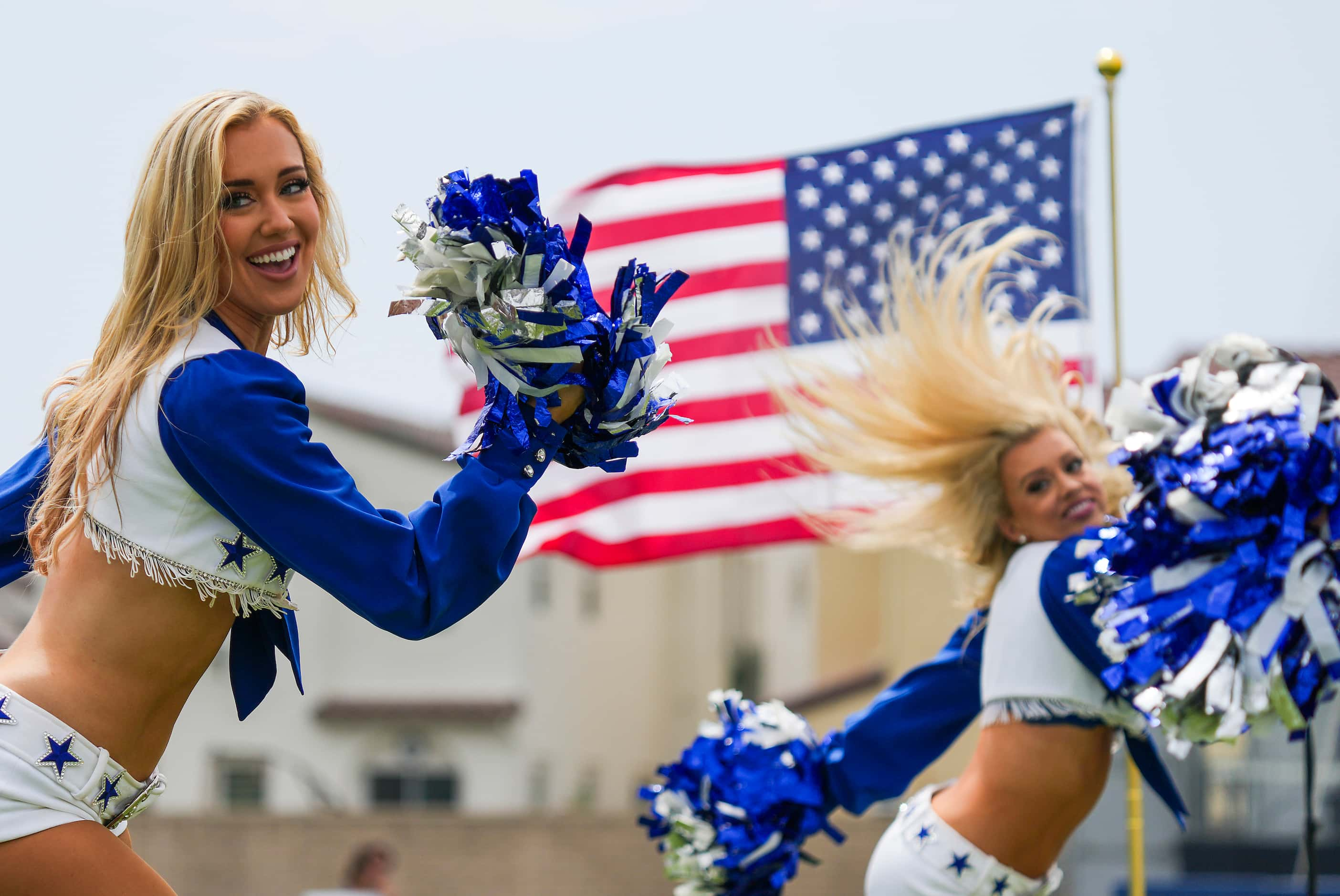 The Dallas Cowboys Cheerleaders perform during opening ceremonies before a training camp...