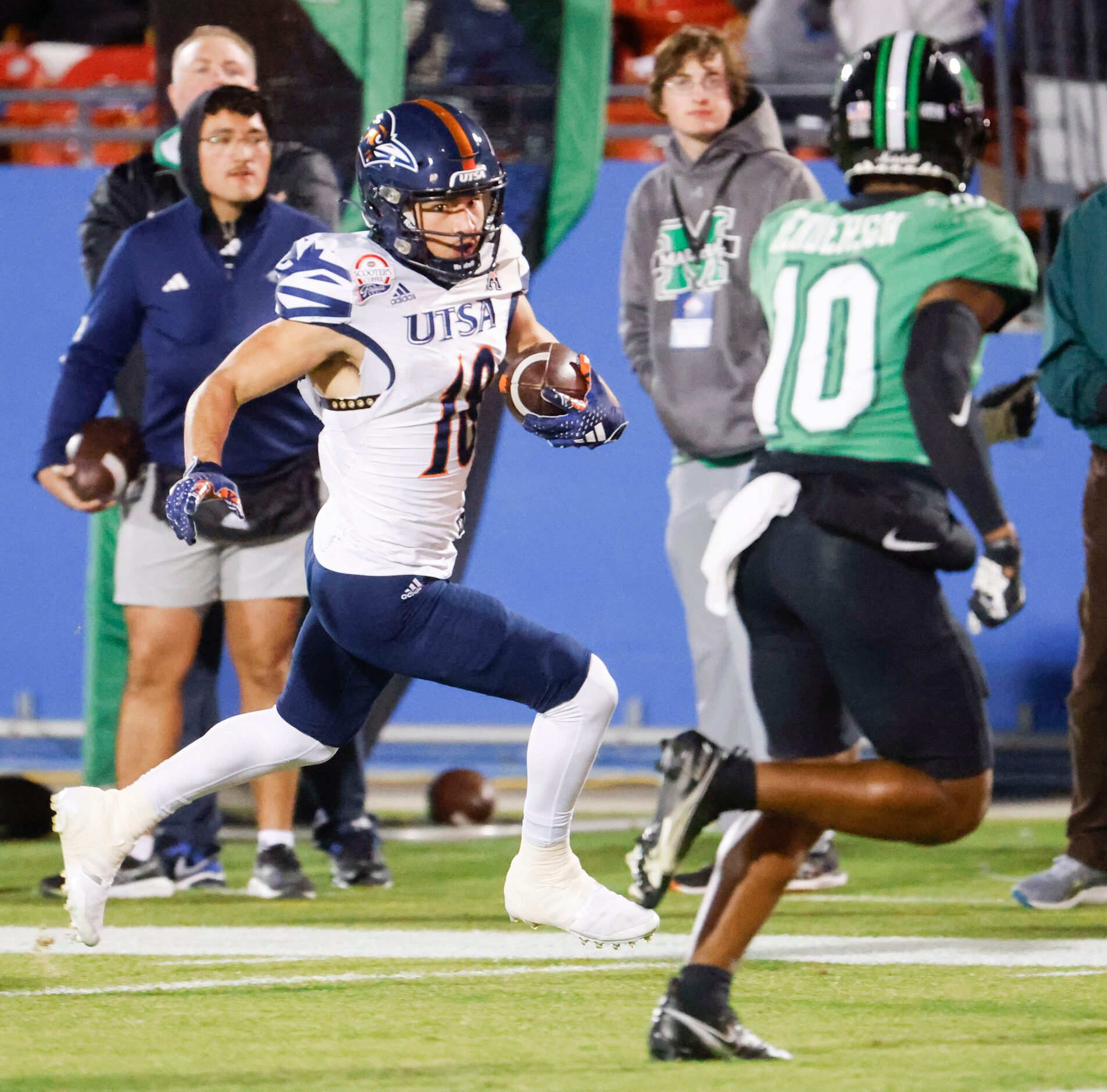 UTSA wide receiver David Amador (left) looks to run for a touchdown past Marshall safety...