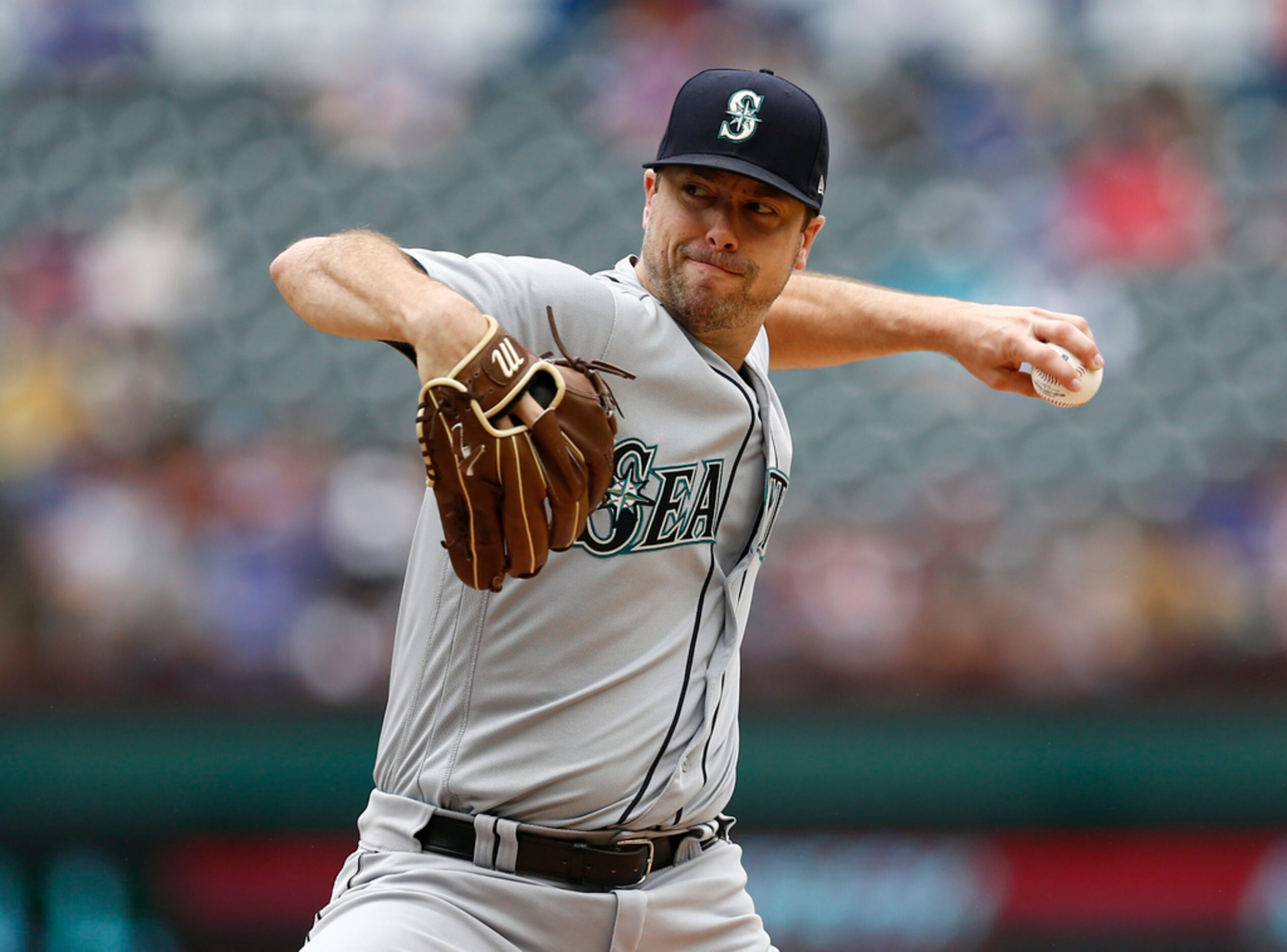 Seattle Mariners starting pitcher Wade LeBlanc delivers a pitch to a Texas Rangers batter...