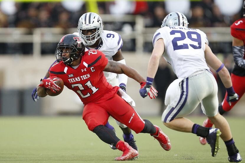 Texas Tech running back DeAndre Washington tries to turn away from Kansas State defensive...