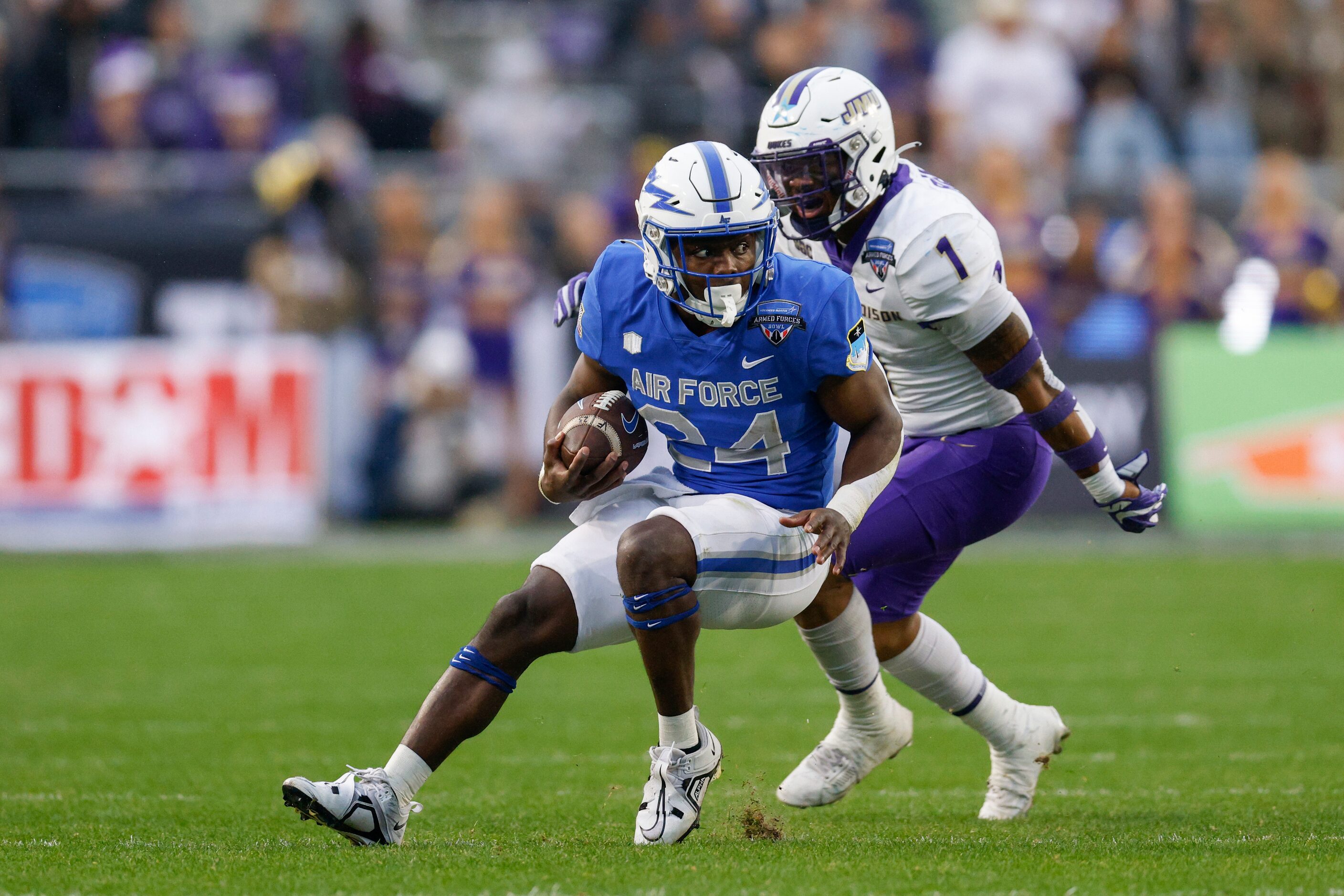 Air Force Falcons running back John Lee Eldridge III (24) cuts to avoid James Madison Dukes...