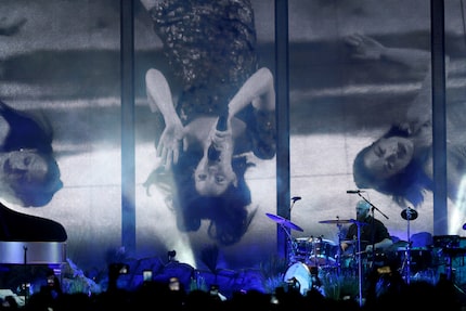 Lana Del Rey performs while lying down on stage at the American Airlines Center in Dallas on...