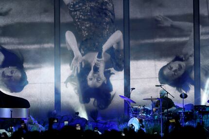 Lana Del Rey performs while lying down on stage at the American Airlines Center in Dallas on...